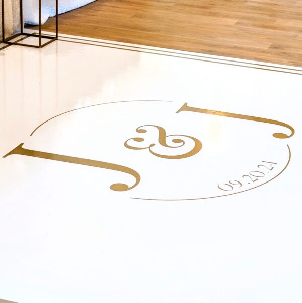 white gloss dance floor wrap with gold monogram