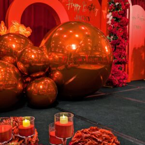 red pvc balls backdrop, red arches, red rose garlands, red candles, red rose balls