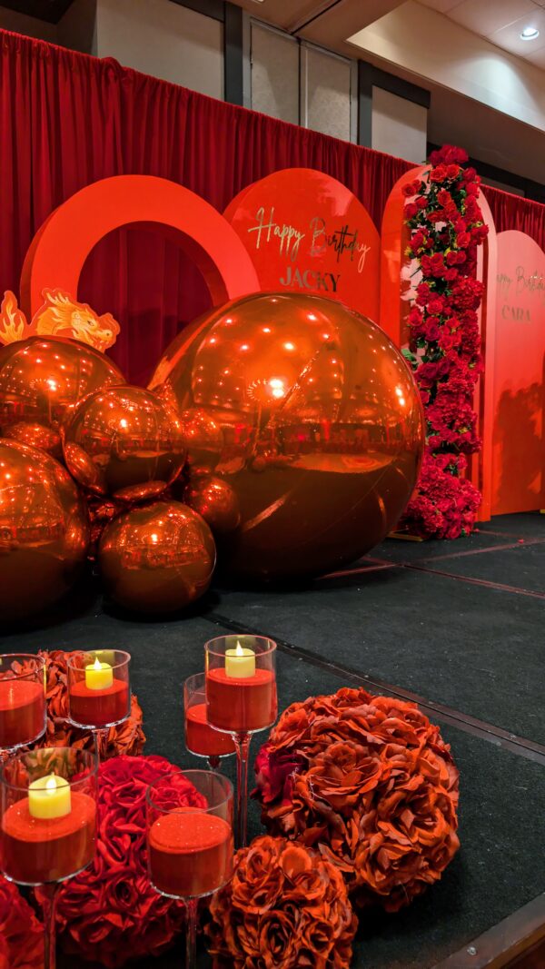 red pvc balls backdrop, red arches, red rose garlands, red candles, red rose balls