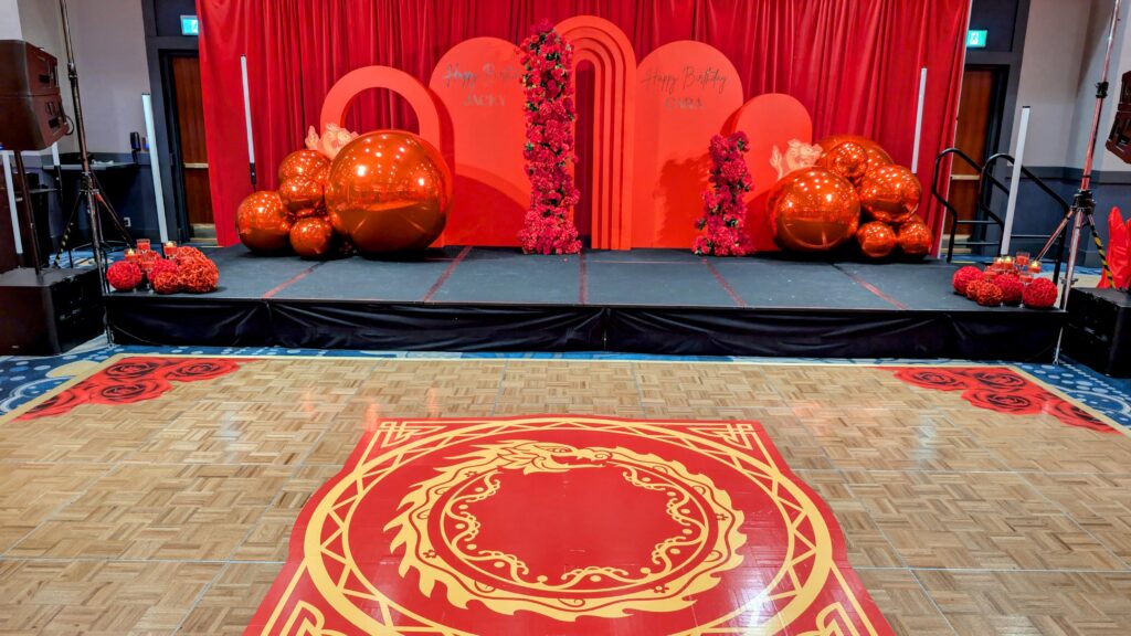 red arch backdrop with red dragono floor decal